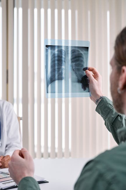 Medical professional examining an X-ray image of human lungs in a clinical setting.